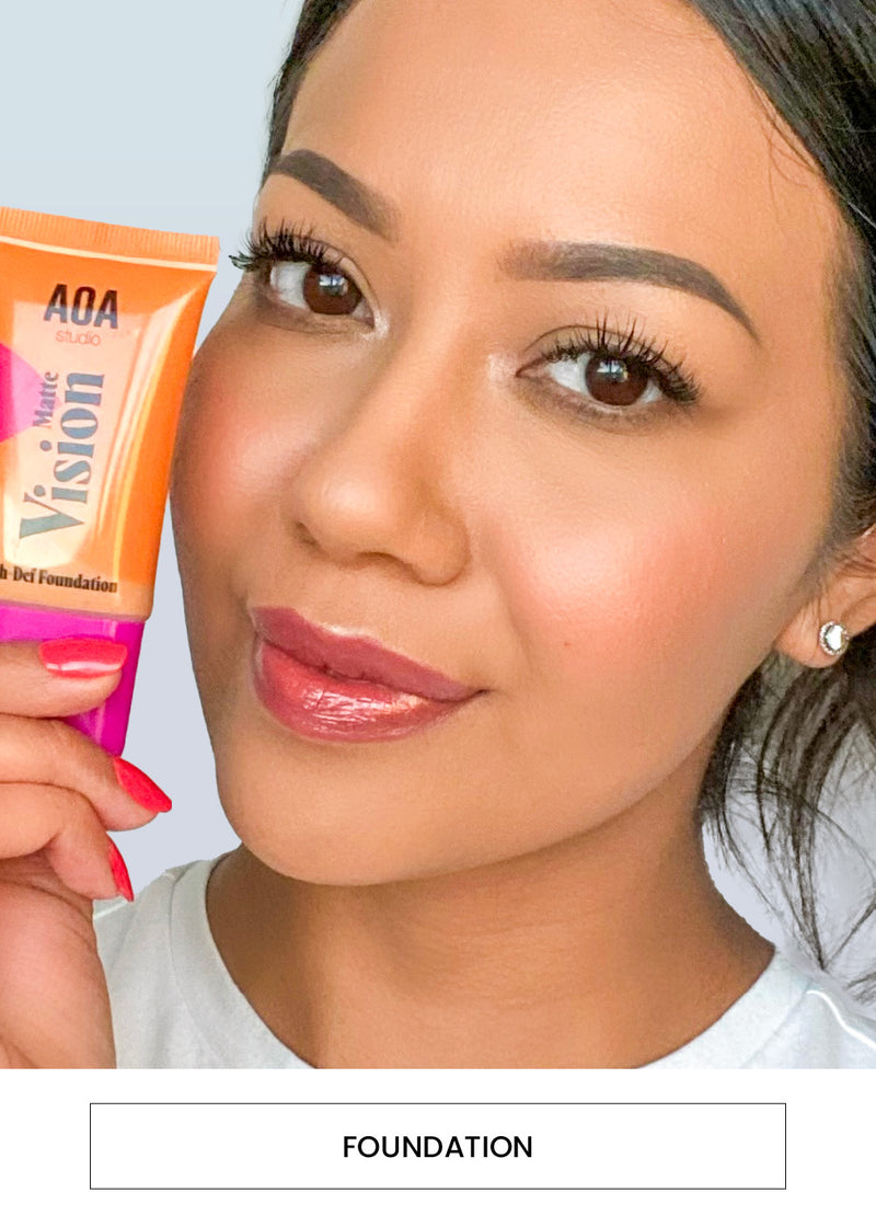 Image of a woman wearing and holding the  Matte Vision Hi-Def Foundation alongside a  “Foundation” button
