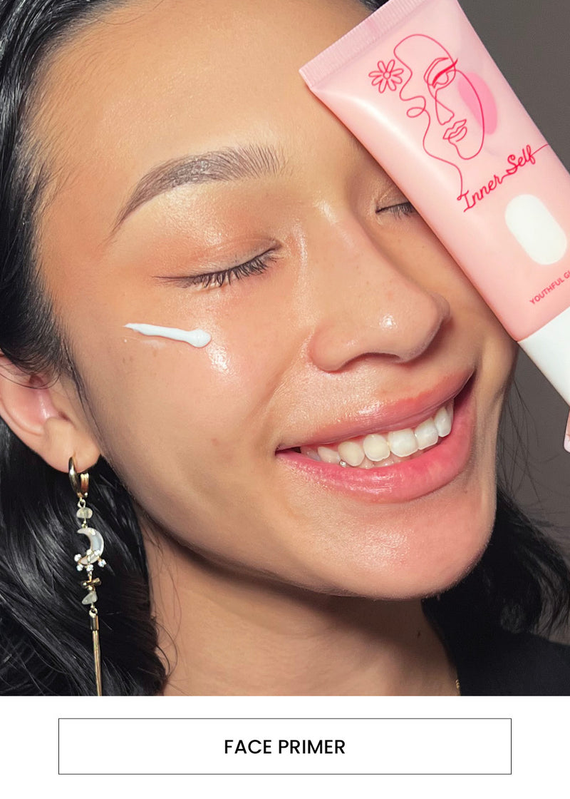 Image of a woman wearing face primer and holding on to the Inner Self Youthful Glow Primer tube alongside a “Face Primer” button