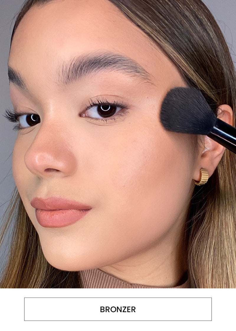 Image of a woman applying bronzer with a brush alongside a  “Bronzer” button