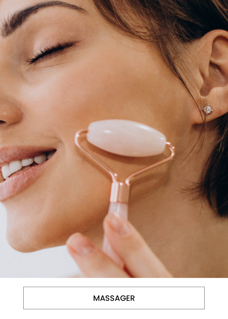 Image of a woman rolling a AOA Pro Double Roller Facial Massaging Tool Roller on her cheek alongside a  “Massager” button