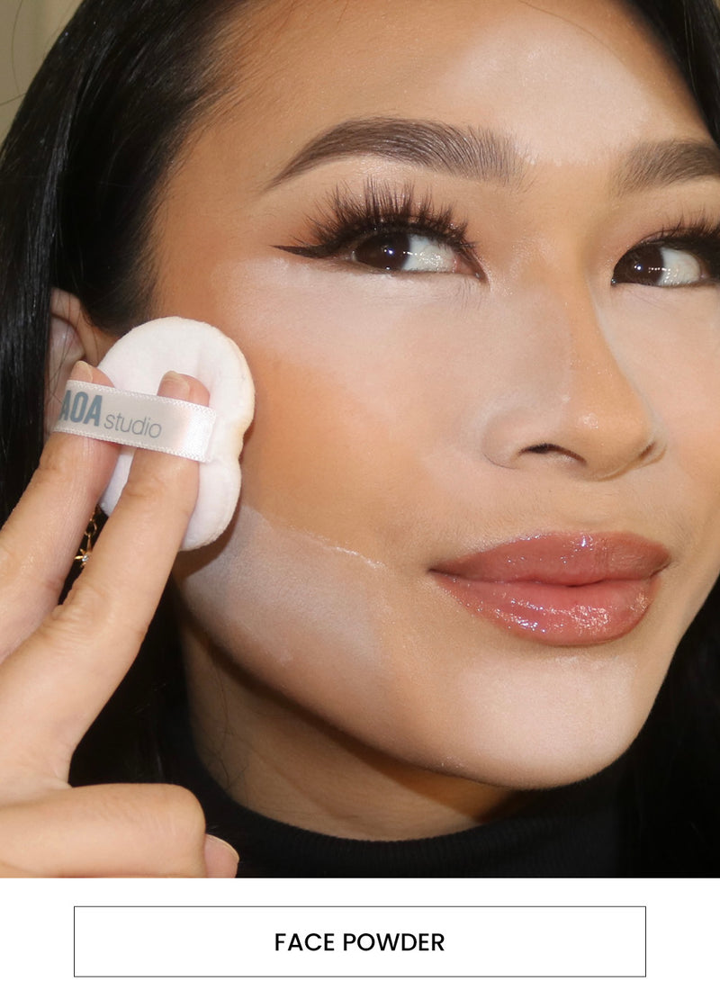 Image of a woman applying face powder on her face with a velvet puff alongside a  “Face Powder” button