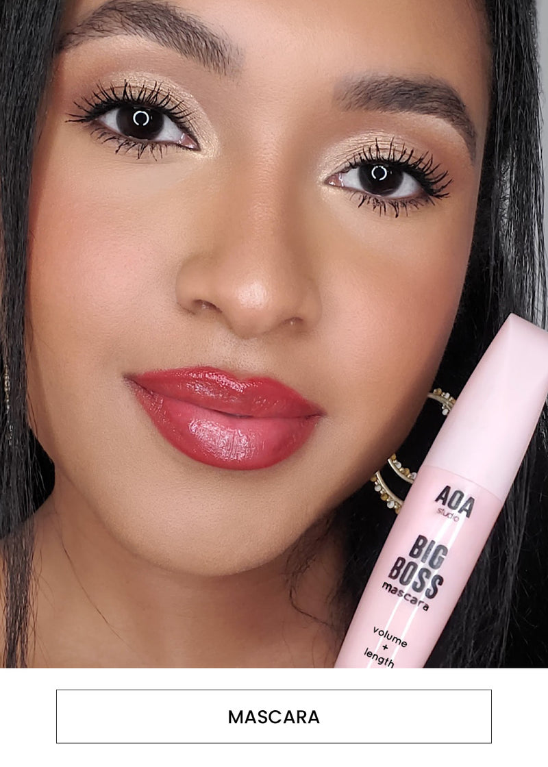 Image of a woman wearing the AOA Big Boss Mascara on her lashes alongside a “Mascara” button
