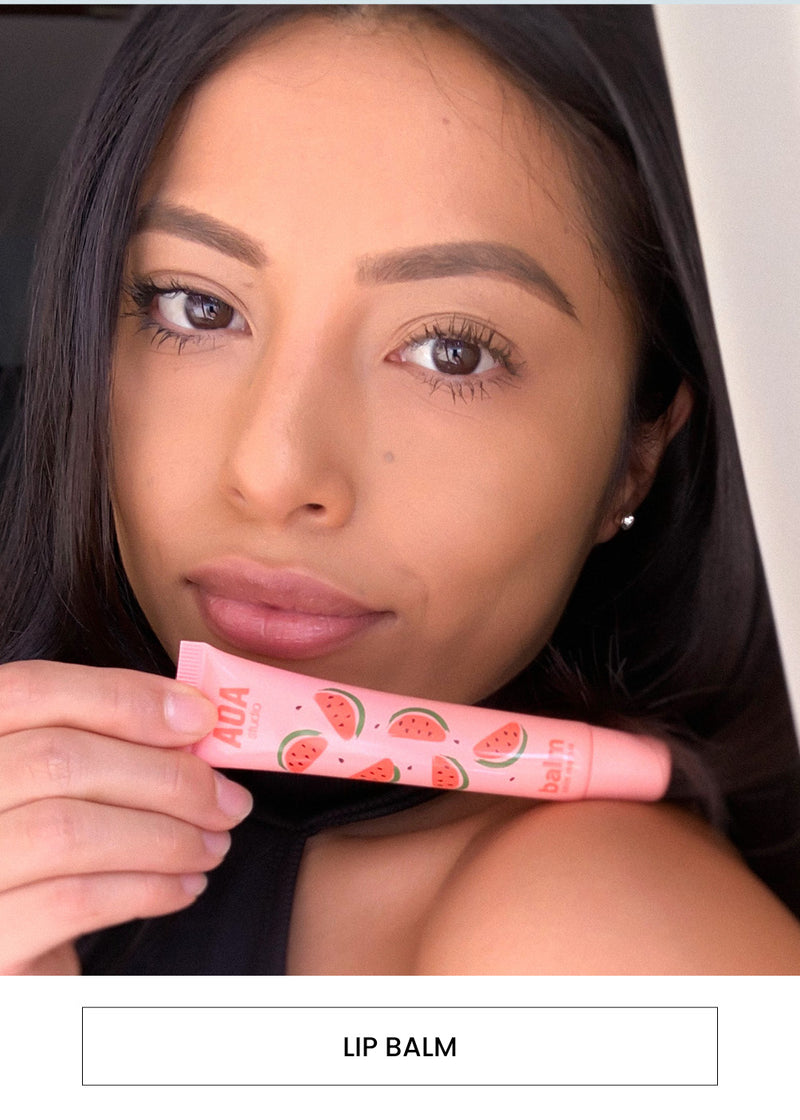 Image of a woman wearing  Skin Rescue Balm on her lips alongside a  “Lip Balm” button
